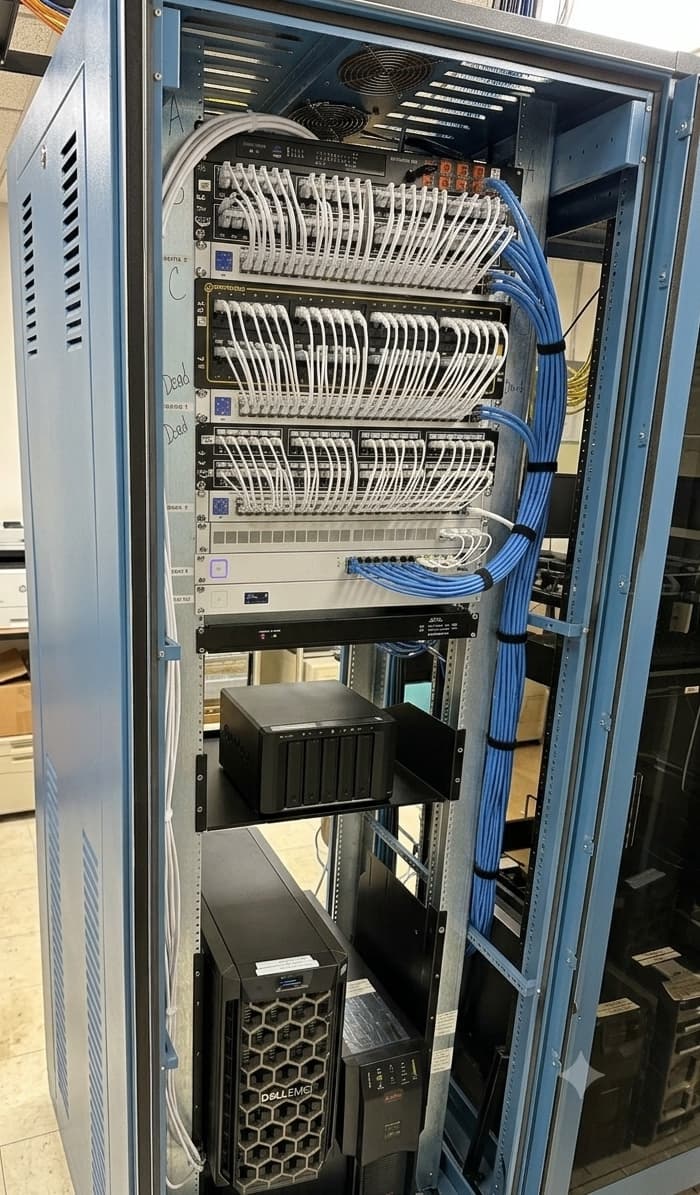 The same rack after structured cabling - dressed cable bundles, labeled runs, and clear equipment access
